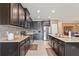 Spacious kitchen with dark wood cabinets, granite countertops, stainless steel appliances and tile backsplash at 18620 Cortes Creek Blvd, Spring Hill, FL 34610