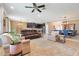 Open-concept living room featuring a leather sofa, dining area, a ceiling fan, and tile flooring throughout at 18620 Cortes Creek Blvd, Spring Hill, FL 34610