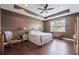 Large main bedroom featuring a tray ceiling, ceiling fan, and hardwood floors at 18620 Cortes Creek Blvd, Spring Hill, FL 34610