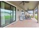 Covered patio with tile floor and outdoor furniture at 18620 Cortes Creek Blvd, Spring Hill, FL 34610