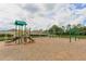 Community playground with slides, swings, and a soft, wood-chip ground cover at 18620 Cortes Creek Blvd, Spring Hill, FL 34610