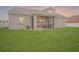 Spacious backyard with green grass and a screened lanai for outdoor entertaining at 1905 Via Napoli St, Plant City, FL 33566