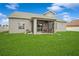 Spacious backyard with green grass and a screened lanai for outdoor entertaining at 1905 Via Napoli St, Plant City, FL 33566
