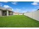Expansive green backyard, complete with a screened patio and a privacy fence at 1905 Via Napoli St, Plant City, FL 33566