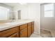 Bathroom with a double sink vanity, large mirror, and a walk-in shower at 1905 Via Napoli St, Plant City, FL 33566