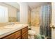 Bathroom featuring a vanity, toilet, and shower-tub combination with decorative shower curtain at 1905 Via Napoli St, Plant City, FL 33566