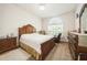 Cozy bedroom featuring a wooden bed frame, ample natural light, and comfortable furnishings at 1905 Via Napoli St, Plant City, FL 33566