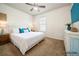 Bright bedroom featuring a neatly made bed, a dresser, and a ceiling fan at 1905 Via Napoli St, Plant City, FL 33566