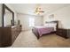 This primary bedroom features a ceiling fan, a window for natural light, and includes dressers for storage at 1905 Via Napoli St, Plant City, FL 33566