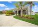 Home exterior features a covered entry way, lush landscaping, and a concrete driveway at 1905 Via Napoli St, Plant City, FL 33566