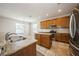 Bright kitchen showcases wooden cabinets, granite countertops, an island, and stainless appliances at 1905 Via Napoli St, Plant City, FL 33566