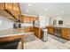 Kitchen features wooden cabinets, granite countertops, stainless steel appliances, and tile flooring at 1905 Via Napoli St, Plant City, FL 33566