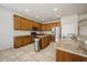Spacious kitchen featuring wooden cabinets, granite countertops, stainless steel appliances, and an island at 1905 Via Napoli St, Plant City, FL 33566