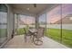 Screened lanai with a table and seating, offering a peaceful outdoor space with views of the backyard at 1905 Via Napoli St, Plant City, FL 33566