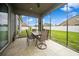 Screened lanai with a table and seating, offering a peaceful outdoor space with views of the backyard at 1905 Via Napoli St, Plant City, FL 33566