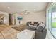Spacious living room with tile flooring, plush rug, and large gray sectional sofa at 1905 Via Napoli St, Plant City, FL 33566