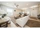 Comfortable living room with neutral furniture, plush rugs, and open layout connecting to the dining area at 1905 Via Napoli St, Plant City, FL 33566