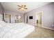 Spacious primary bedroom with purple walls, a ceiling fan, and ensuite bathroom access at 1905 Via Napoli St, Plant City, FL 33566