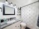 Bathroom with turtle themed shower curtain, granite countertops and a modern vanity at 2214 Elise Marie Dr, Seffner, FL 33584