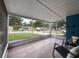 Spacious screened front porch offers a relaxing view of the quiet neighborhood street at 2214 Elise Marie Dr, Seffner, FL 33584