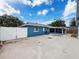View of the side of the house, showing the garage and fenced in backyard at 2214 Elise Marie Dr, Seffner, FL 33584