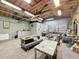 Spacious garage features seating area, storage cabinets, and roll up door for versatile use at 2214 Elise Marie Dr, Seffner, FL 33584