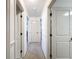 Hallway with neutral carpeting and multiple doorways leading to other rooms at 2214 Elise Marie Dr, Seffner, FL 33584