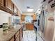 Kitchen featuring stainless steel appliances, granite counters, and classic wood cabinets at 2214 Elise Marie Dr, Seffner, FL 33584