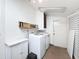 Well-lit laundry room with modern machines and overhead lighting at 2214 Elise Marie Dr, Seffner, FL 33584
