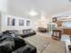 Open-concept living room featuring a large comfortable sofa and adjacent dining area at 2214 Elise Marie Dr, Seffner, FL 33584