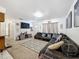Comfortable living room with a large sofa, stylish decor, and a view of the home's entrance at 2214 Elise Marie Dr, Seffner, FL 33584