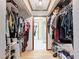 Walk-in closet with custom shelving, plenty of storage space, and hardwood floors at 2214 Elise Marie Dr, Seffner, FL 33584
