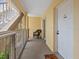 Cozy outdoor balcony space with a chair and a view, leading to a unit entrance at 2424 Placida Rd # D102, Englewood, FL 34224