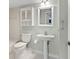 Well-lit bathroom with tiled floors, built-in storage, modern fixtures and pedestal sink at 2424 Placida Rd # D102, Englewood, FL 34224
