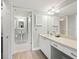 Bright bathroom featuring tiled floors, wide counters, ample storage and walk-in access at 2424 Placida Rd # D102, Englewood, FL 34224