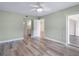 Light fills the bedroom featuring hard wood floors, light green walls, and entry to bathroom at 2424 Placida Rd # D102, Englewood, FL 34224