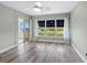 Bedroom with large window overlooking water, neutral paint, ceiling fan, with sliding door to balcony at 2424 Placida Rd # D102, Englewood, FL 34224