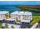 Exterior view of condo complex with covered parking and waterfront scenery at 2424 Placida Rd # D102, Englewood, FL 34224