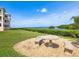 Exterior shot of property with a stone table set and beautiful views of the water at 2424 Placida Rd # D102, Englewood, FL 34224