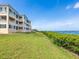 Exterior shot of property showcasing a lush green lawn and calming water views at 2424 Placida Rd # D102, Englewood, FL 34224