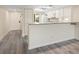 Bright kitchen featuring white cabinetry, modern appliances, and sleek gray wood-look flooring at 2424 Placida Rd # D102, Englewood, FL 34224