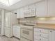 Bright kitchen features white cabinets, modern appliances, and a clean, updated design at 2424 Placida Rd # D102, Englewood, FL 34224