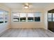 Bright living room with beautiful water view through large windows and light wood floors at 2424 Placida Rd # D102, Englewood, FL 34224