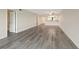 Open-concept living room featuring light wood floors, neutral walls, and ample space at 2424 Placida Rd # D102, Englewood, FL 34224