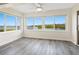 Bright living room with beautiful water view through large windows and light wood floors at 2424 Placida Rd # D102, Englewood, FL 34224
