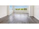 Bright living room with beautiful water view through large windows and light wood floors at 2424 Placida Rd # D102, Englewood, FL 34224