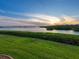 Expansive water view showcasing a beautiful sunset over lush greenery and calm water at 2424 Placida Rd # D102, Englewood, FL 34224
