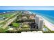 Breathtaking aerial view of beachfront condos near a golf course, offering the ultimate lifestyle at 2425 Gulf Of Mexico Dr # 14B, Longboat Key, FL 34228