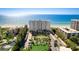 Stunning aerial view showcasing a condo complex located directly on a pristine white sandy beach at 2425 Gulf Of Mexico Dr # 14B, Longboat Key, FL 34228