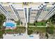 High-rise beachfront condo featuring a pool, beach access, and manicured landscaping in a prime location at 2425 Gulf Of Mexico Dr # 14B, Longboat Key, FL 34228